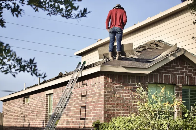 Professional roofer working on a residential roof in Banks